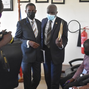 The Attorney General Hon. Kiryoowa Kiwanuka leaves the boardroom with Commission Meddie Mulumba, Chairperson of the Commission