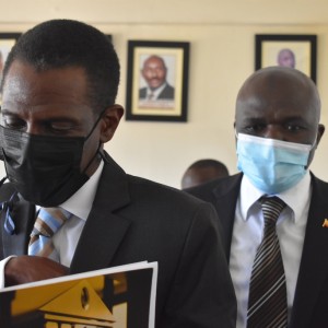 The Attorney General Hon. Kiryoowa Kiwanuka leaves the boardroom with Commissioner Meddie Mulumba, Chairperson of the Commission